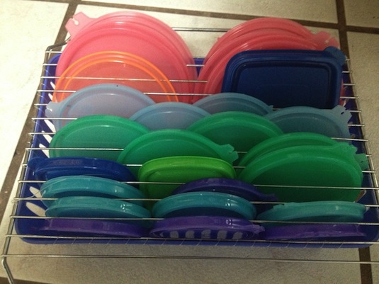 DIY easy tupperware lid storage -- Easy DIY small kitchen organization ideas and storage tips for your cabinets, your countertops, under your sink and in your pantry! I'll bet you could go to the dollar store or dollar tree and do these projects for cheap. These hacks are great for apartments! Listotic.com  