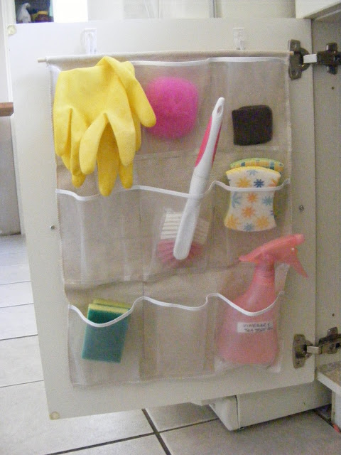 Pocket organizer under the sink for small items that get lost. -- Easy DIY small kitchen organization ideas and storage tips for your cabinets, your countertops, under your sink and in your pantry! I'll bet you could go to the dollar store or dollar tree and do these projects for cheap. These hacks are great for apartments! Listotic.com  