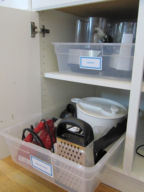 Pretend kitchen cabinet pull-outs using large plastic storage tubs. -- Easy DIY small kitchen organization ideas and storage tips for your cabinets, your countertops, under your sink and in your pantry! I'll bet you could go to the dollar store or dollar tree and do these projects for cheap. These hacks are great for apartments! Listotic.com 