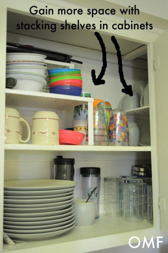 Use stacking shelves to utilize vertical space in your cabinets. -- Easy DIY small kitchen organization ideas and storage tips for your cabinets, your countertops, under your sink and in your pantry! I'll bet you could go to the dollar store or dollar tree and do these projects for cheap. These hacks are great for apartments! Listotic.com  