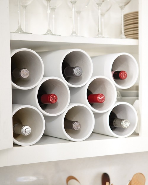 How to organize wine bottle for cheap. -- Easy DIY small kitchen organization ideas and storage tips for your cabinets, your countertops, under your sink and in your pantry! I'll bet you could go to the dollar store or dollar tree and do these projects for cheap. These hacks are great for apartments! Listotic.com  