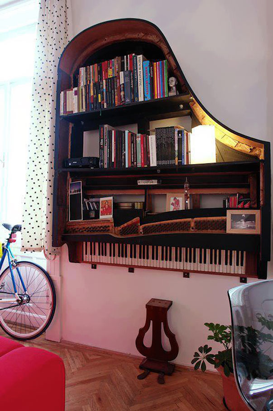 Old grand piano turned into a beautiful book shelf. -- Easy DIY furniture makeovers and ideas! A lot of repurposed thrift store projects and chalk paint ideas so that you can do it for cheap. Before and after photos of dressers, tables, shelves, tv stands and more! For bedrooms and living rooms. Listotic.com