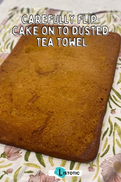 baked pumpkin roll on dusted tea towel