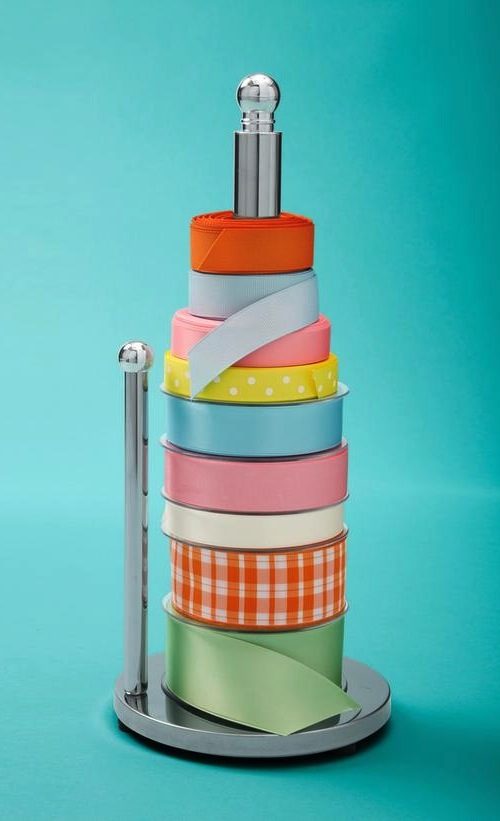 50 Genius Storage Ideas ~ Use a paper towel holder to store ribbon!