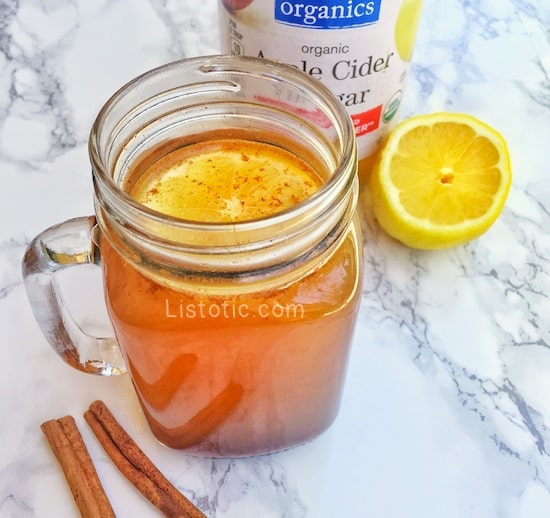 Apple cider vinegar drink with cinnamon sticks and lemon.