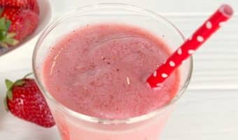 Strawberry Smoothie in a glass with red straw.