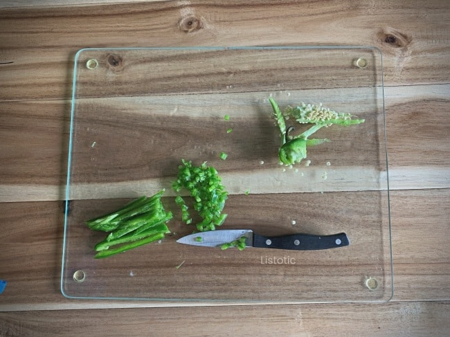 Jalapenos chopped on a cutting board for party poppers.