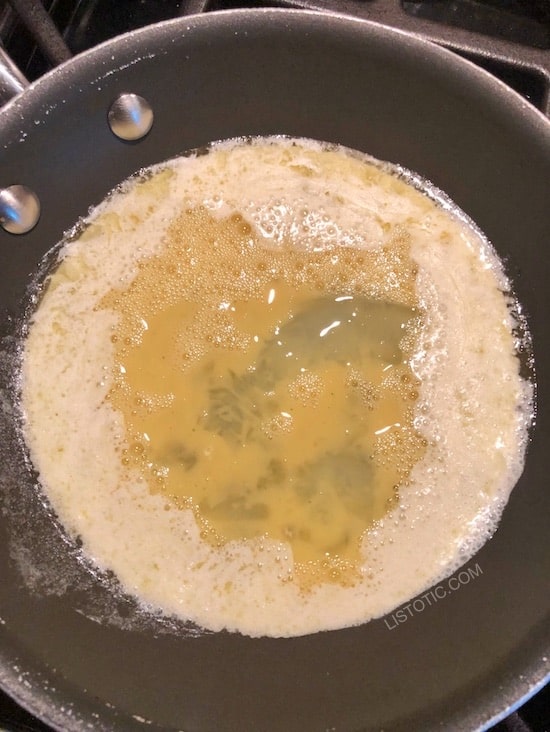 Melted butter, heavy cream and eggs just starting to cook for scrambled eggs.