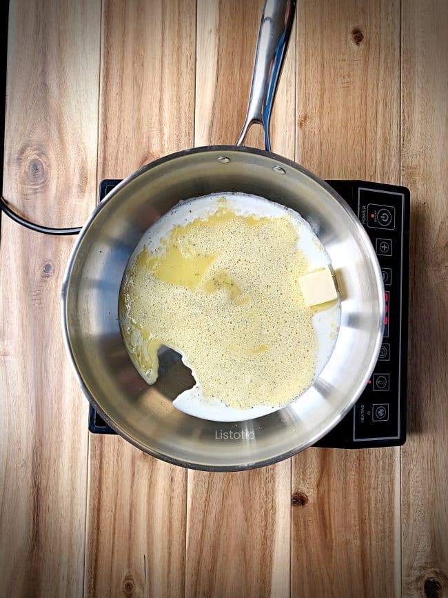 Skillet with butter and whipping cream.