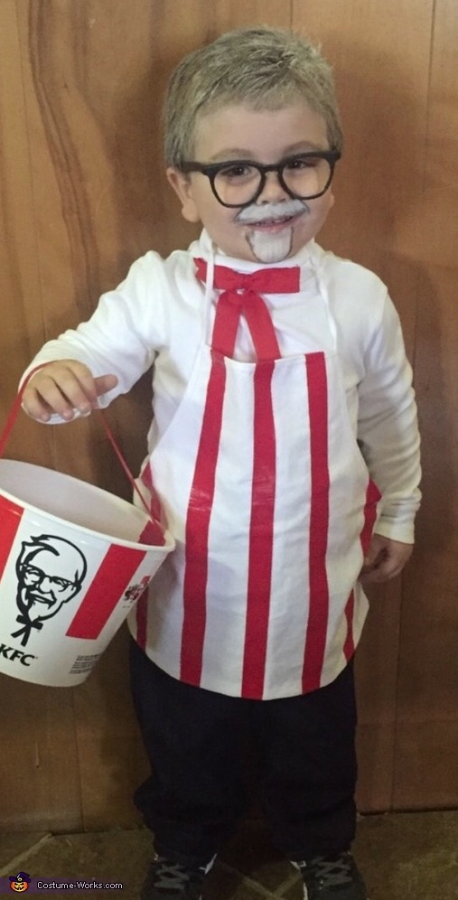 Homemade Colonel Sanders Costume-- KFC and chicken! So cute and funny for toddlers. Red and white striped apron, white shirt, red tie, black glasses and fake beard and mustache.