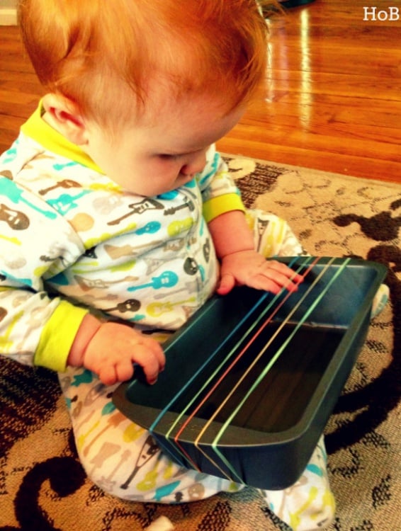 Easy DIY guitar using rubber bands and loaf pan for infants to create music. 