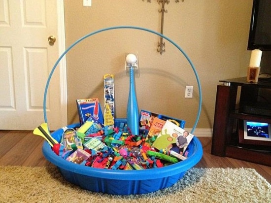 Kiddie pool filled with Easter themed gifts and summer toys such as a hula hoop, baseball bat and ball, bubbles, inflatable pool toys and more!