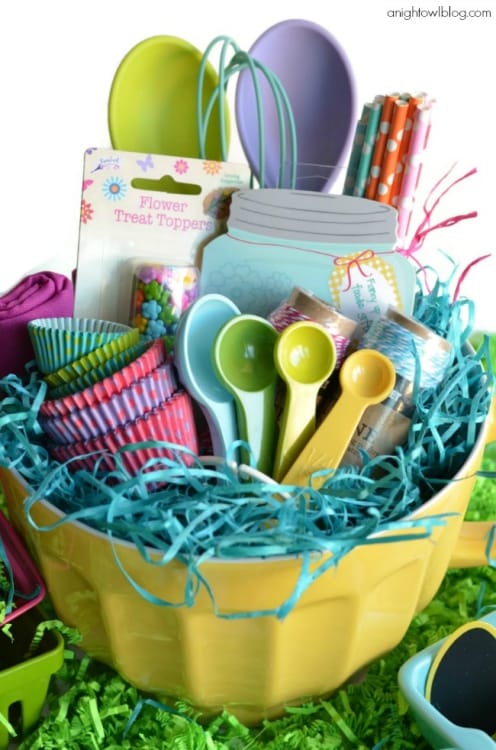 Baking lovers Easter Basket alternative filled with all of your baking essentials such as cupcake liners, measuring spoons, whisks, Easter Bunny sprinkles, notepad, colorful straws and more.