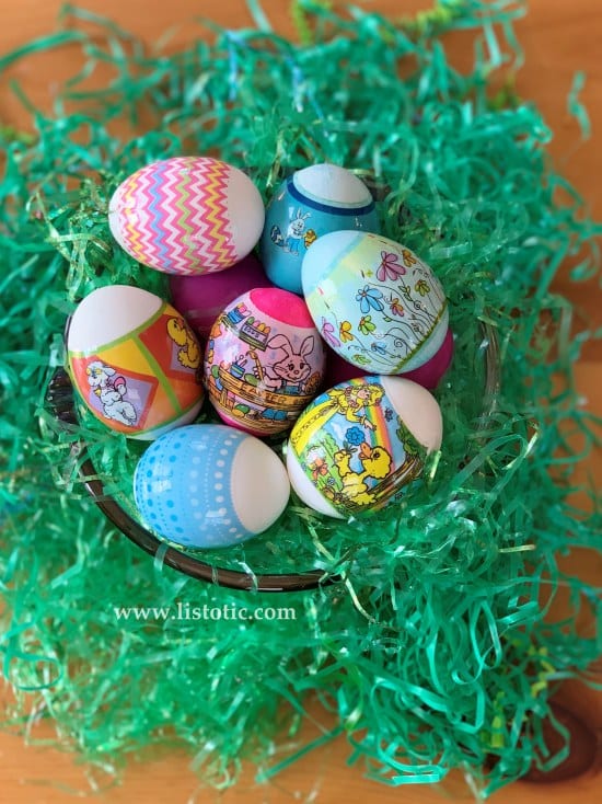 Shrink wrapped dyed Easter Eggs in green grass.