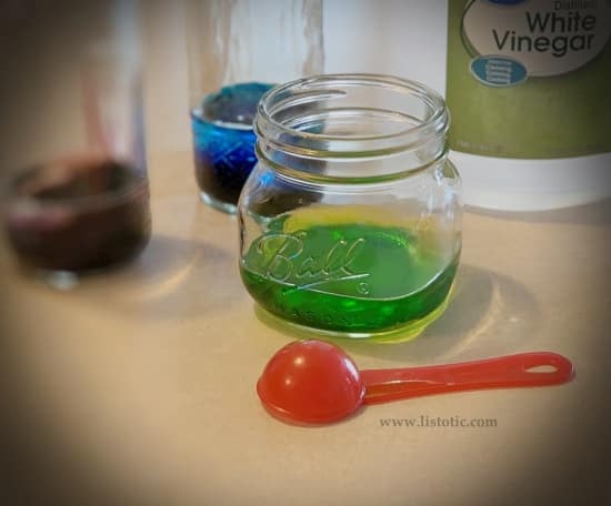 Mason jars with different colored food coloring and white vinegar prepped for Easter egg dying.