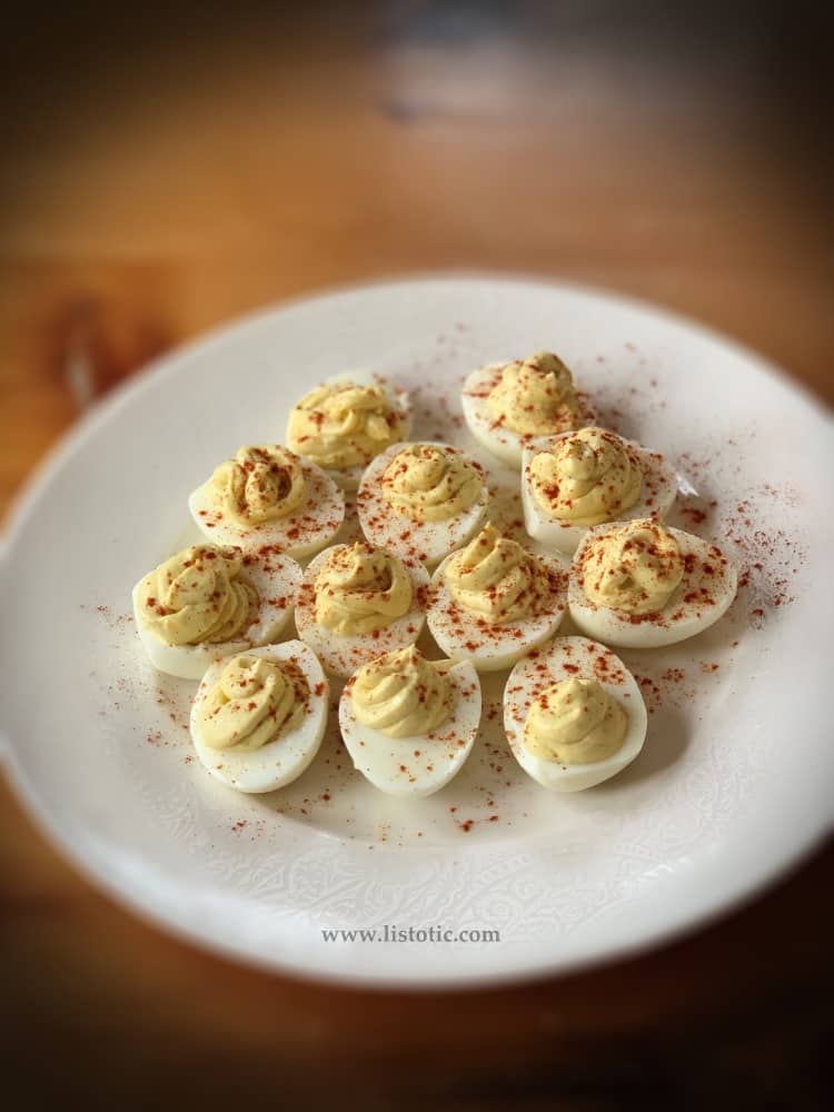 white plate with classic deviled eggs recipe for simple party appetizer or relish tray Refrigerate 1 or more hours before serving