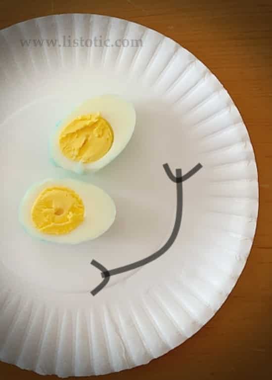 Happy faced sliced hard boiled egg. 