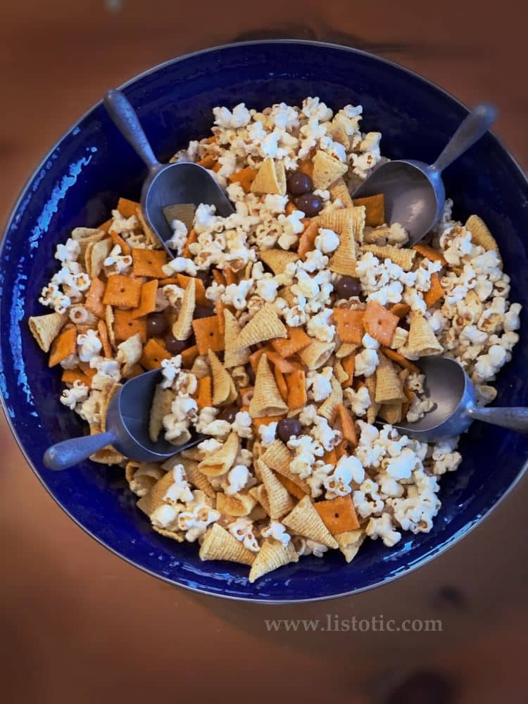 Large bowl with metal scoops of dollar store party snack mix for kids or adults to enjoy at party 