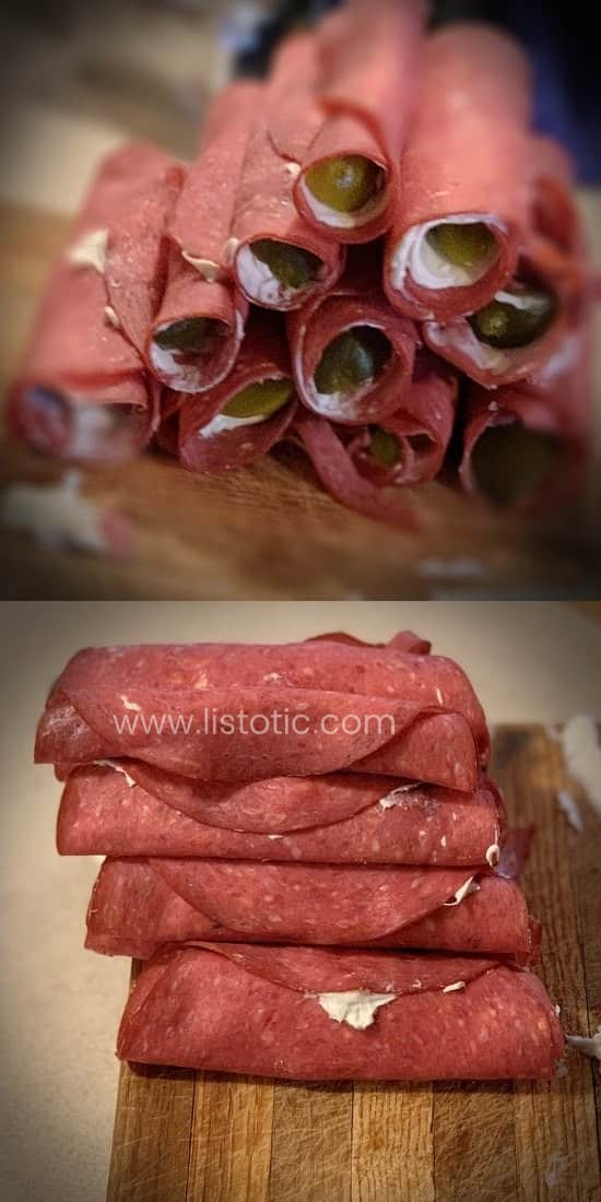 Stacks of rolled up dill pickle spears inside dried beef luncheon meat and cream cheese prepared for party appetizer. 