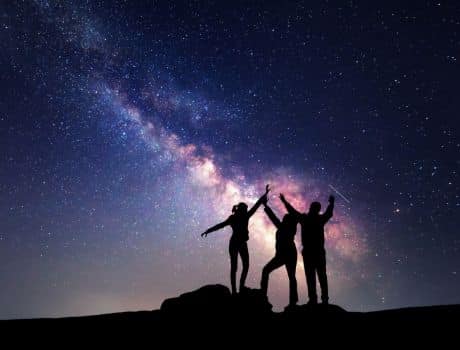 Family stargazing at brilliant sky.