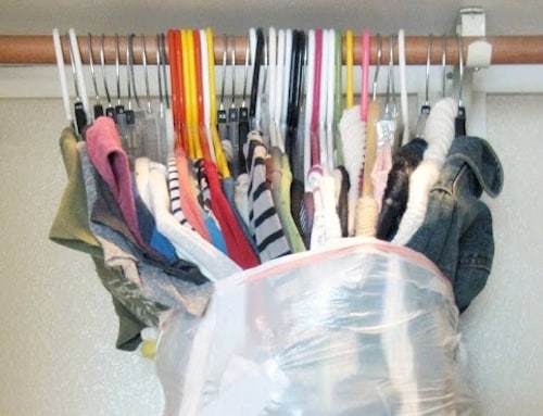 Helpful moving tips - shows garbage bag wrapped around hanging clothes to make moving easier - Listotic Newsletter Feature