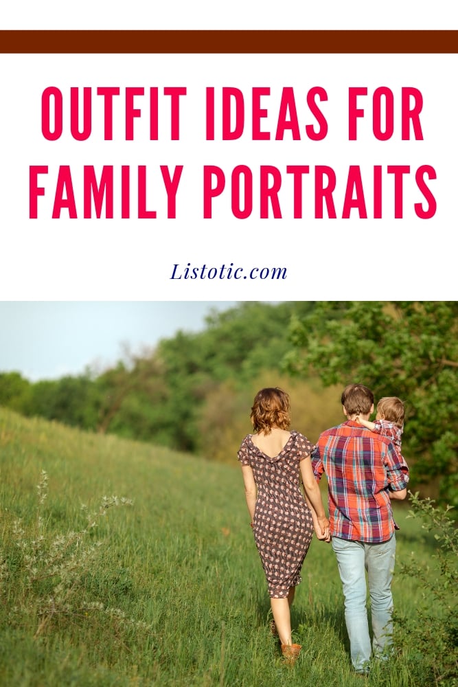 Family of 3 walking wearing patterned clothing with backs turned away from the camera in a green field. Mom and holding dad’s hand and dad caring a baby. 