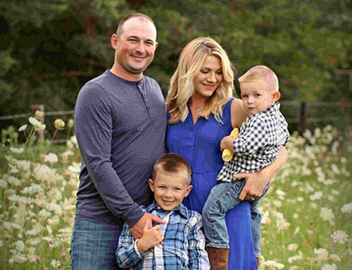 Picture Perfect Family - family of four who are color coordinated in a beautiful field background.