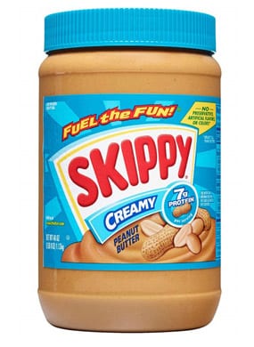 Jar of Skippy Peanut Butter with a blue lid 