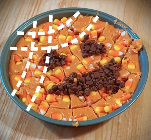 Pan of Halloween candy corn fudge that has been cut into bite size pieces for a Halloween party.