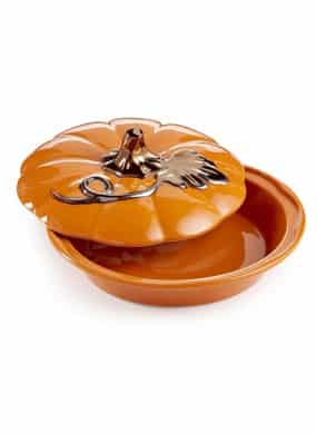 Orange 9 inch round ceramic covered pie dish with stem and leaf on top. 