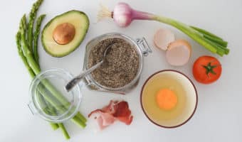 Ingredients including avocado, egg, asparagus and bacon for whole30 breakfast.
