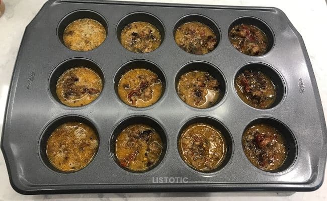 Sausage egg muffins ready to be baked in muffin tin.