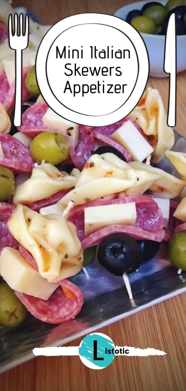 Appetizer plate with cheese and Italian skewers of green and black olives