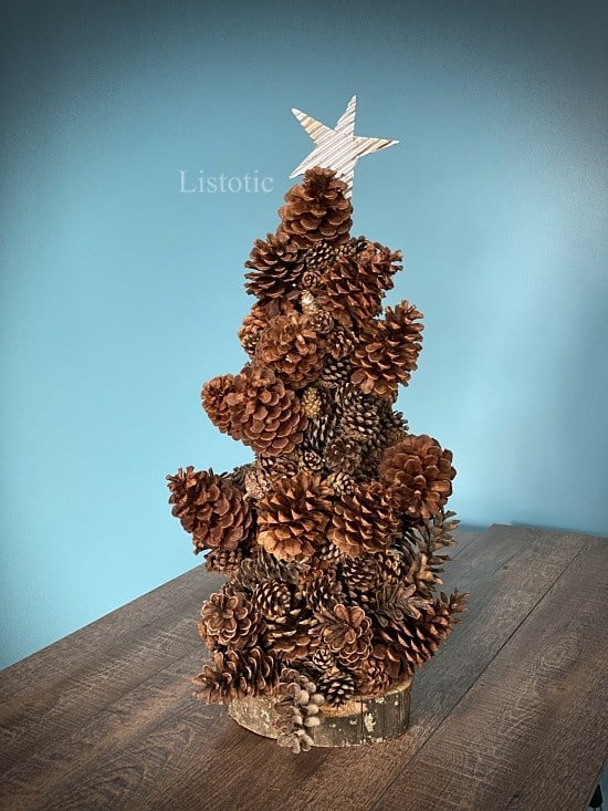 Pine cone Christmas tree craft with recycled cardboard star on top of tree
