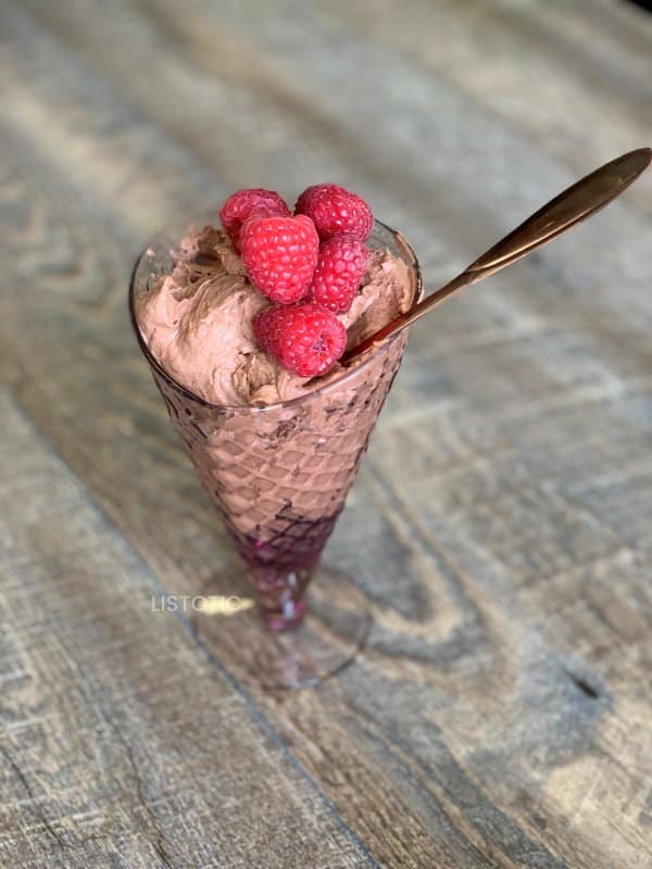 red raspberries on a keto chocolate low carb mousse pudding dessert