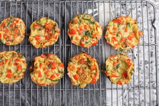 Low carb savory pizza flavored sausage egg muffins displayed on a cooling rack.
