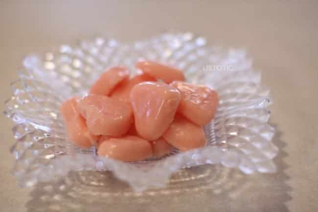 frozen strawberry milk ice cubes shaped like hearts in a glass dish 