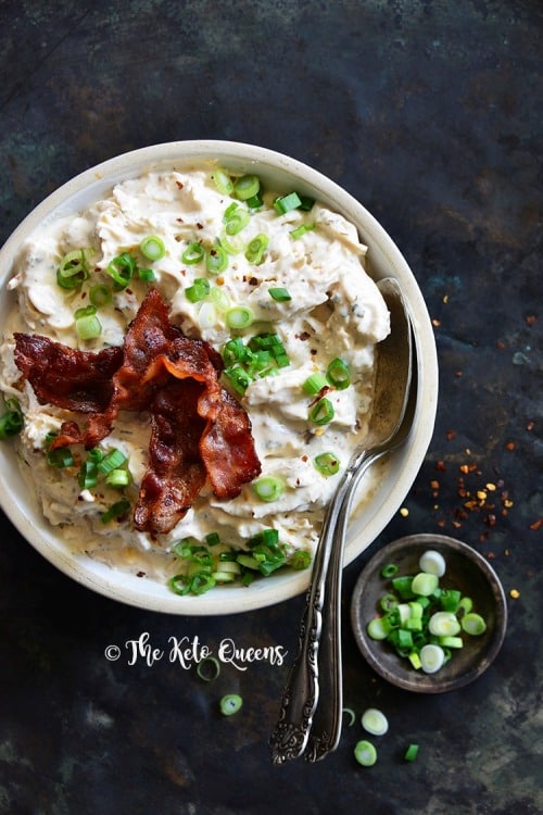 Indulgent Creamy Keto Crack Chicken garnished with scallions and crispy bacon for a savory Keto dinner.