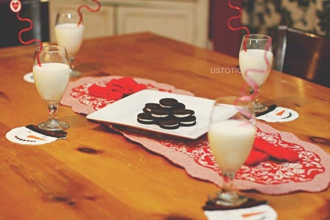 for glasses set on a valentines day tablescape for kids after school snack with strawberry milk and Oreo cookies.