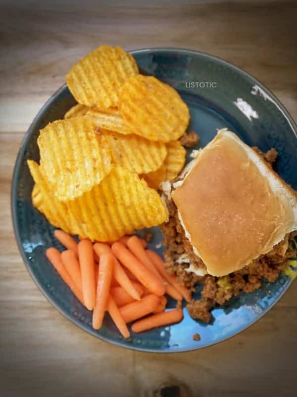 lunch plate with loose meat sandwich carrots and potato chips