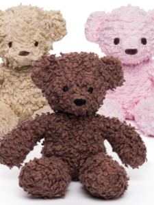 Three teddy bears, one caramel, one brown, and one pink, displayed next to each other.