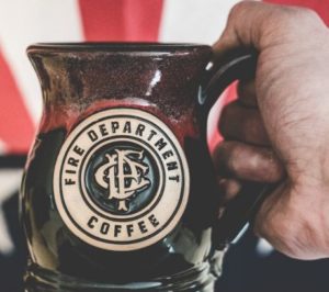 A mug engraved with the Fire Dept. Coffee logo. 