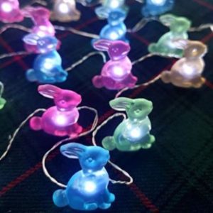 A closeup of lit up Easter bunny string lights.
