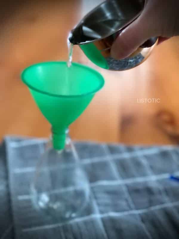 Pouring antibacterial solution into a recycled dispenser