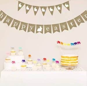 An easter banner hanging above a spread of various desserts.