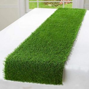 An artificial grass table runner displayed on a white table.