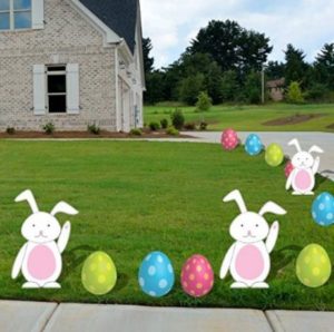 Bunny and egg shaped yard decorations displayed in the lawn.