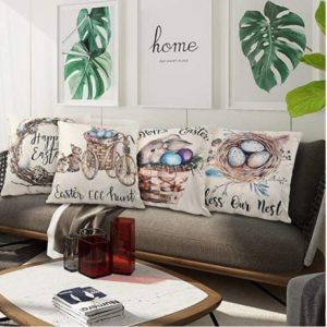 Four easter pillows placed on a couch.