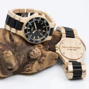 WeWood wooden watches displayed on top of a log. 