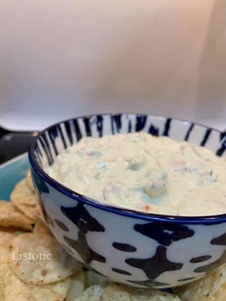 A bowl of avocado ranch dip served with tortilla chips.